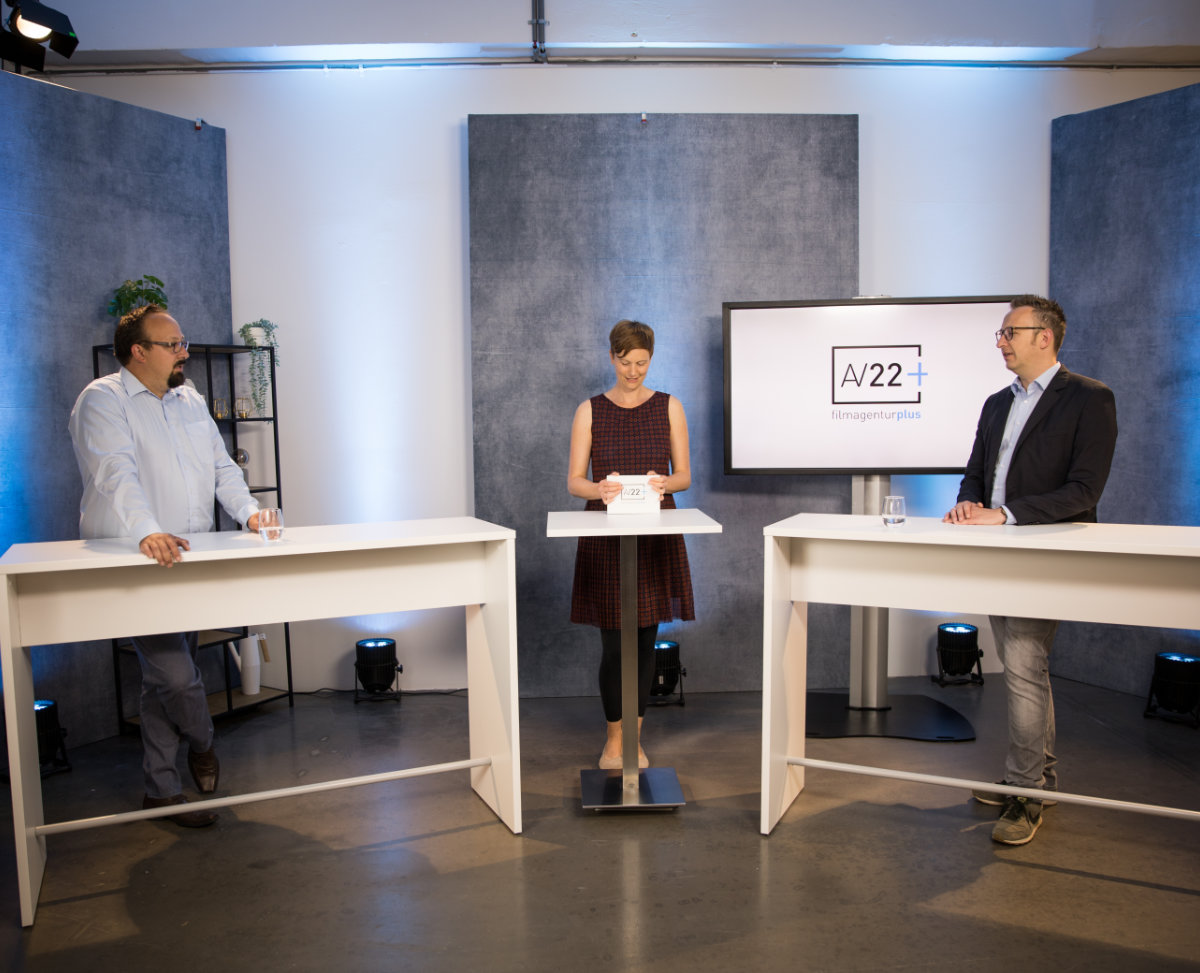 AV22 studio - Julian, Johanna und Philipp stehen an Tresen in professioneller Studioumgebung.